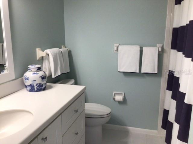 420 Gulf Boulevard, Unit 6 Boca Grande, FL 33921 - Photo 25 of 26 a bathroom with a sink a toilet and a mirror