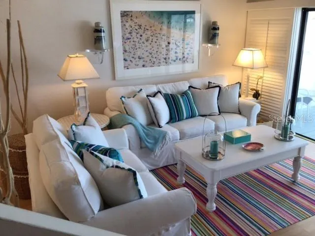 a living room with furniture and a lamp