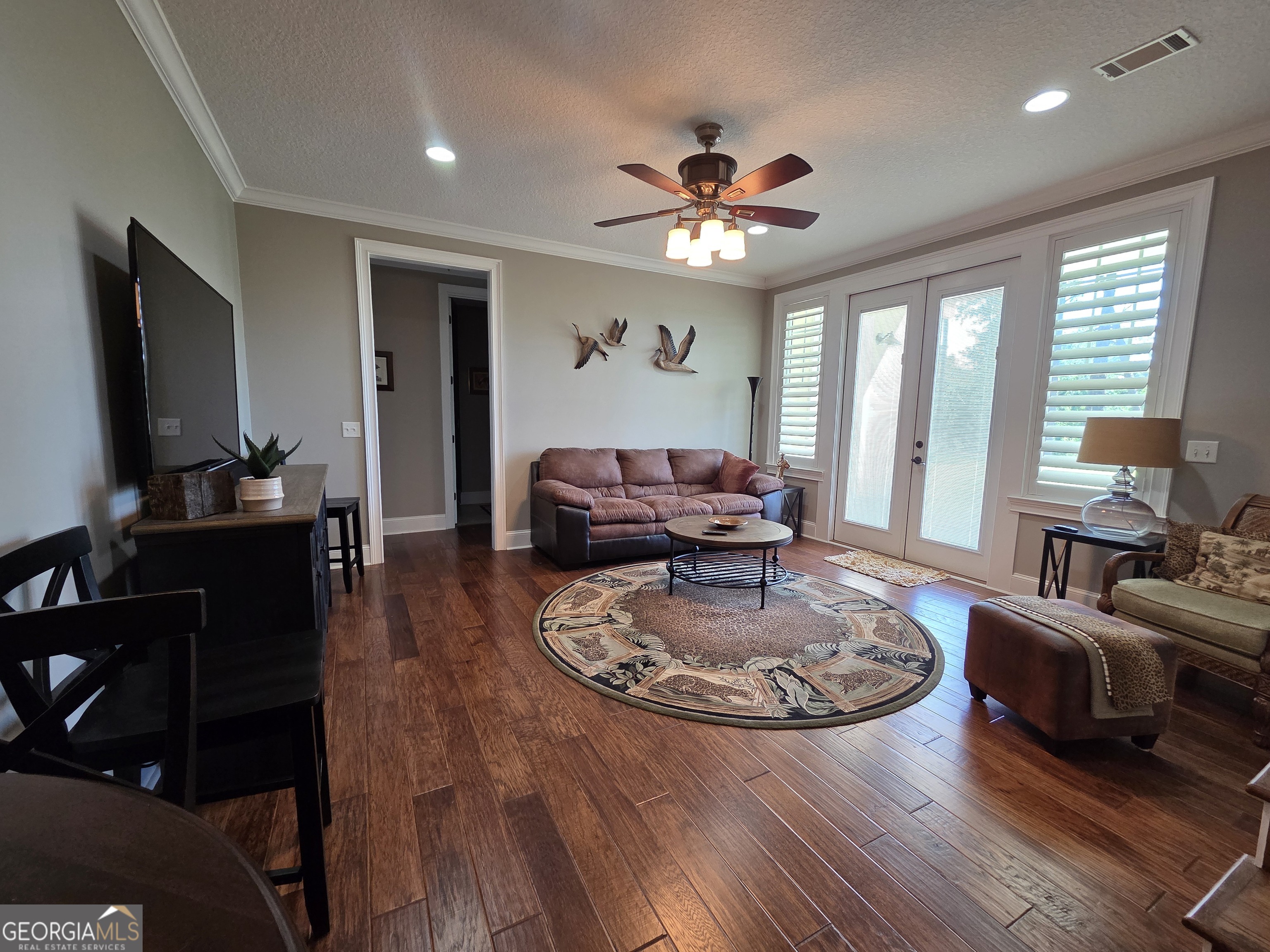 300 Hammond Powell Road Hazlehurst, GA 31539 - Photo 69 of 91 a living room with furniture a large window and a flat screen tv