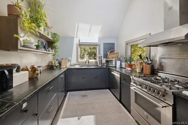 a kitchen with stainless steel appliances a stove a sink dishwasher and a refrigerator