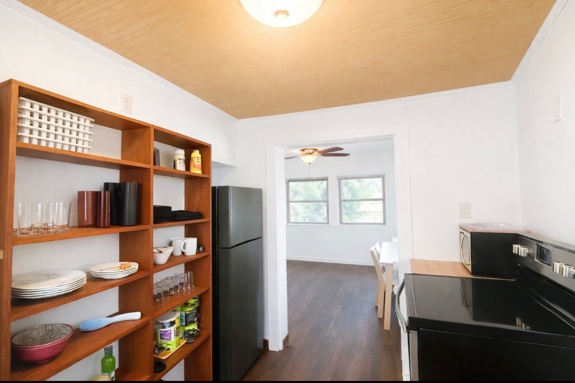 2117 Everett Street, Unit B Houston, TX 77009 - Photo 3 of 7 a kitchen with stainless steel appliances granite countertop a refrigerator and a stove