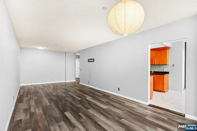 an empty room with a mirror and a window