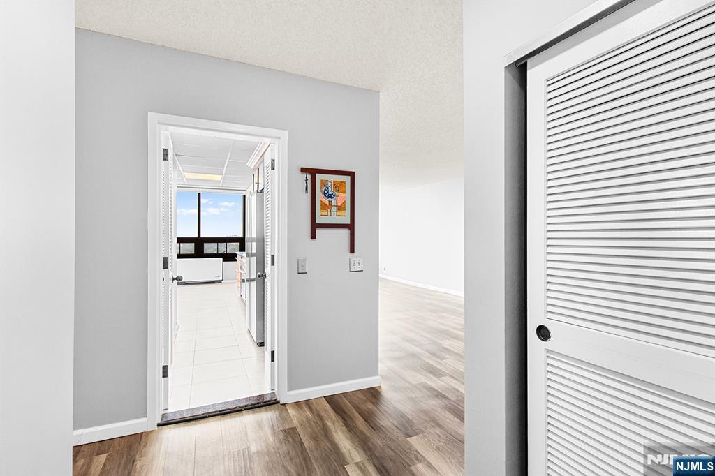 800 Palisade Avenue, Unit 2007 Fort Lee, NJ 07024 - Photo 13 of 21 a view of a hallway with wooden floor and closet