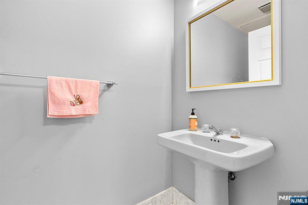 800 Palisade Avenue, Unit 2007 Fort Lee, NJ 07024 - Photo 14 of 21 a bathroom with a sink and a mirror