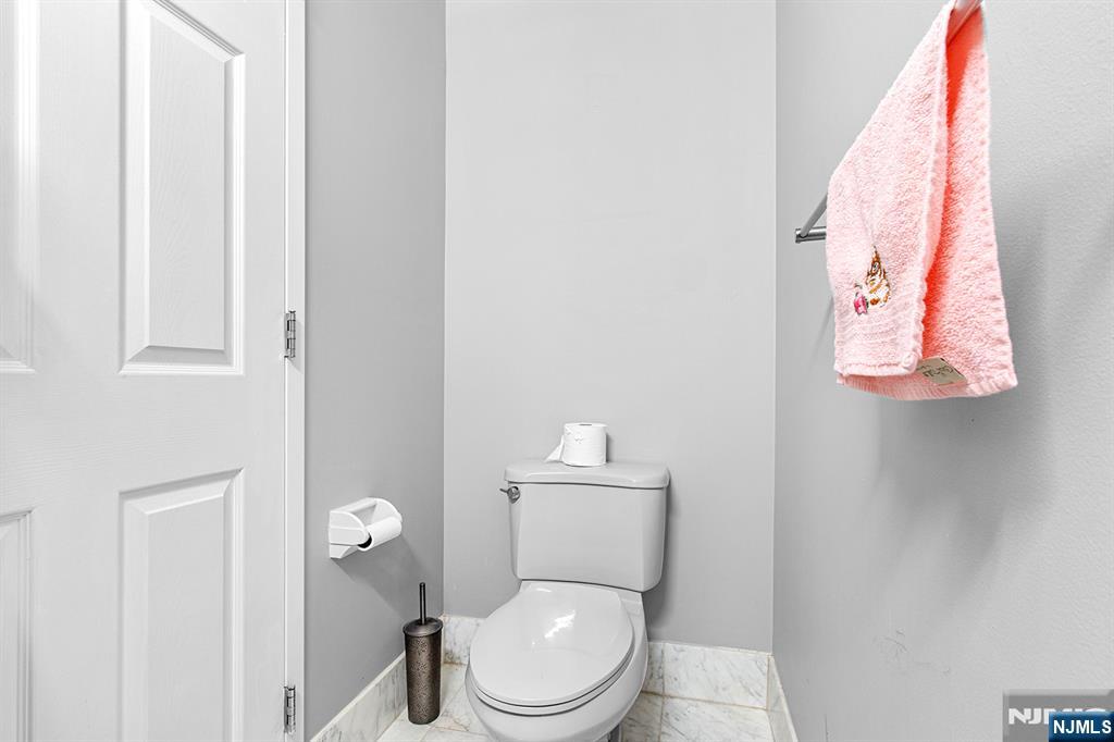 800 Palisade Avenue, Unit 2007 Fort Lee, NJ 07024 - Photo 15 of 21 a white toilet sitting next to a shower curtain