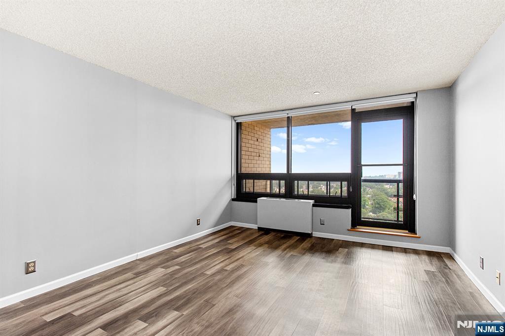 800 Palisade Avenue, Unit 2007 Fort Lee, NJ 07024 - Photo 8 of 21 wooden floor in an empty room with a window