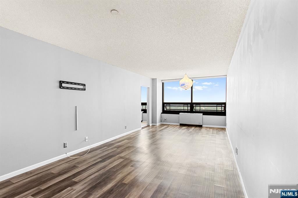 800 Palisade Avenue, Unit 2007 Fort Lee, NJ 07024 - Photo 10 of 21 a view of a livingroom with couch and window