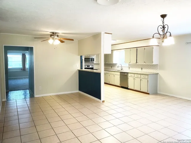 a view of a kitchen with a stove cabinets and wooden floor