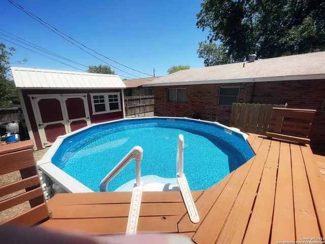 a view of a swimming pool with patio