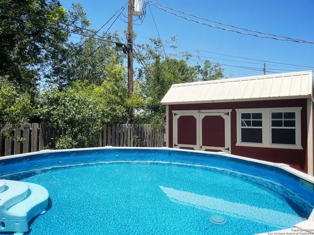 a view of an house with backyard space and balcony