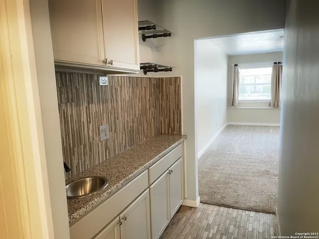 a kitchen with a sink and cabinets