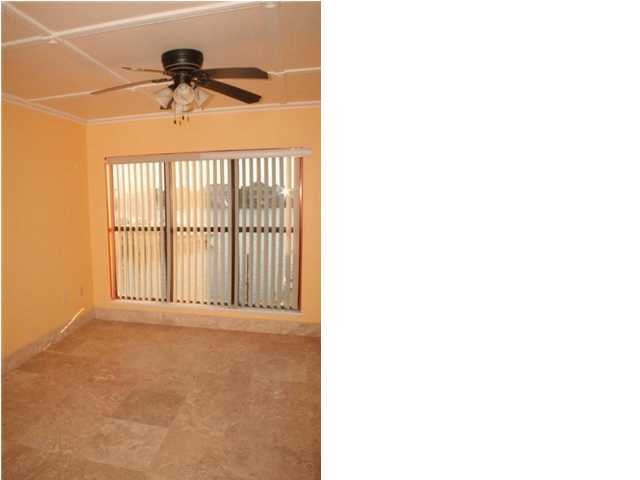 654 Harbor Boulevard, Unit 2 Destin, FL 32541 - Photo 5 of 14 a view of a livingroom with a ceiling fan and a window