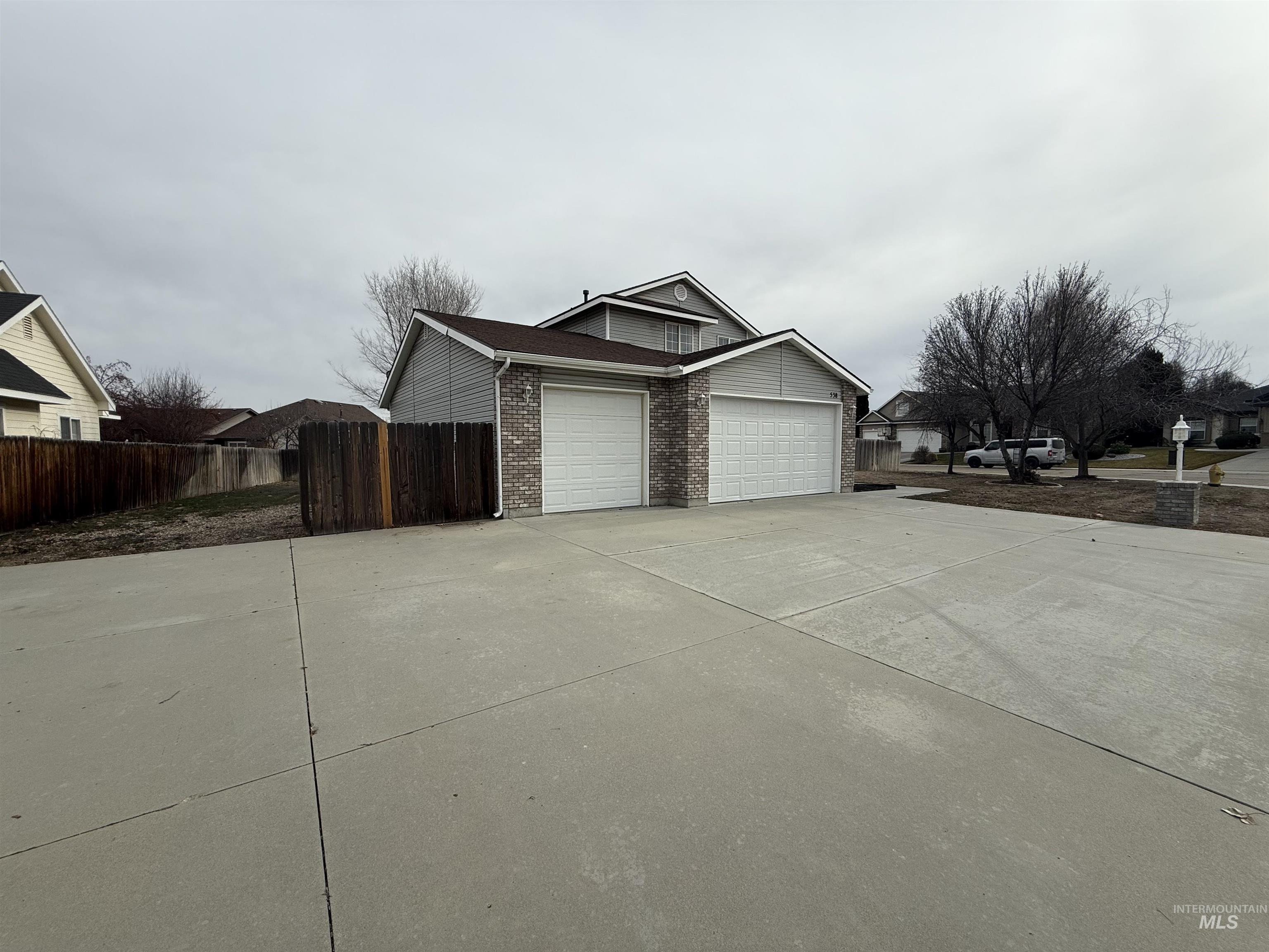 538 Morning Sun Drive Nampa, ID 83686 - Photo 23 of 28 View of home's exterior featuring concrete driveway, brick siding, and an attached garage