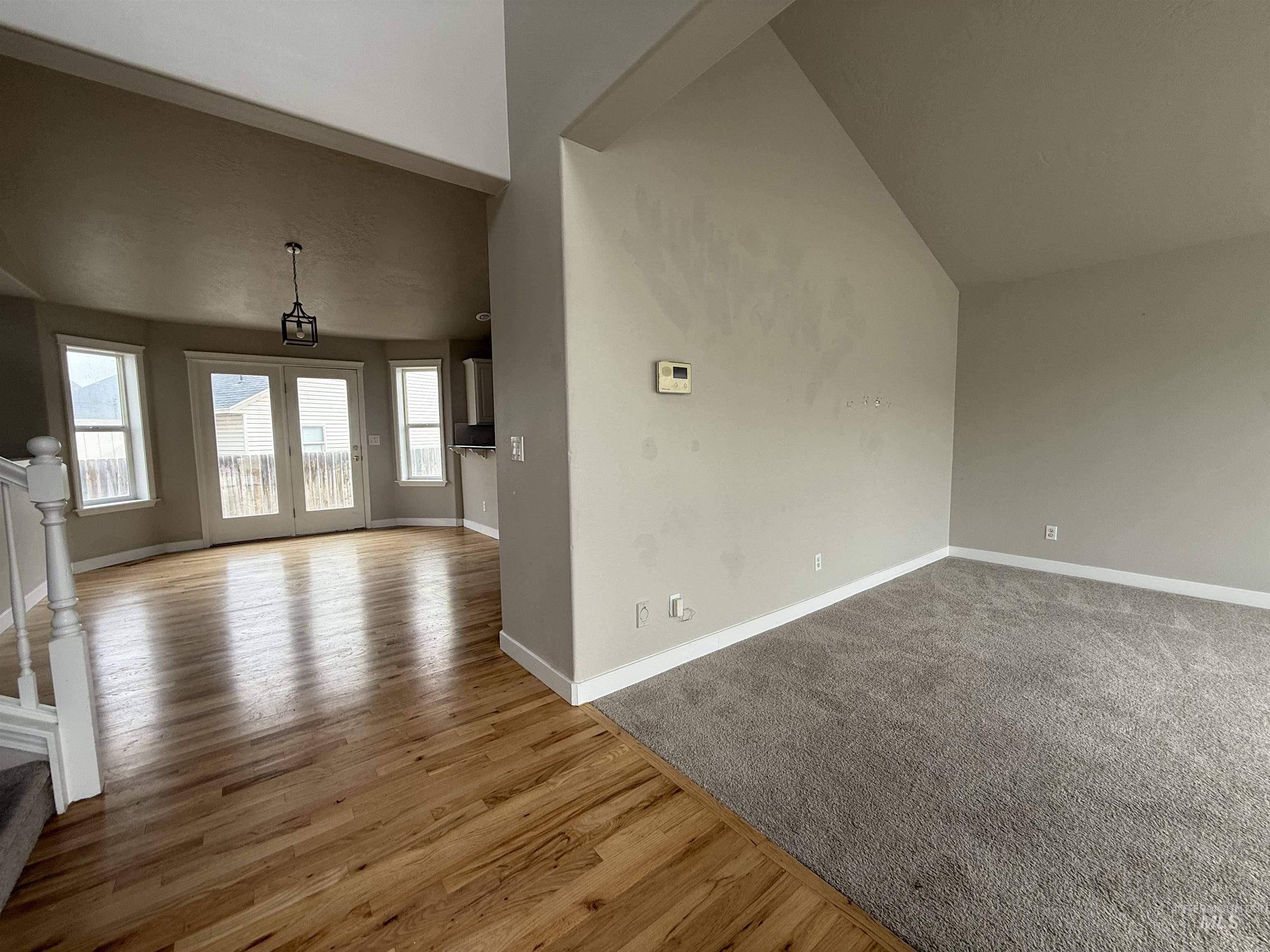 538 Morning Sun Drive Nampa, ID 83686 - Photo 4 of 28 Unfurnished living room featuring vaulted ceiling and light wood-type flooring