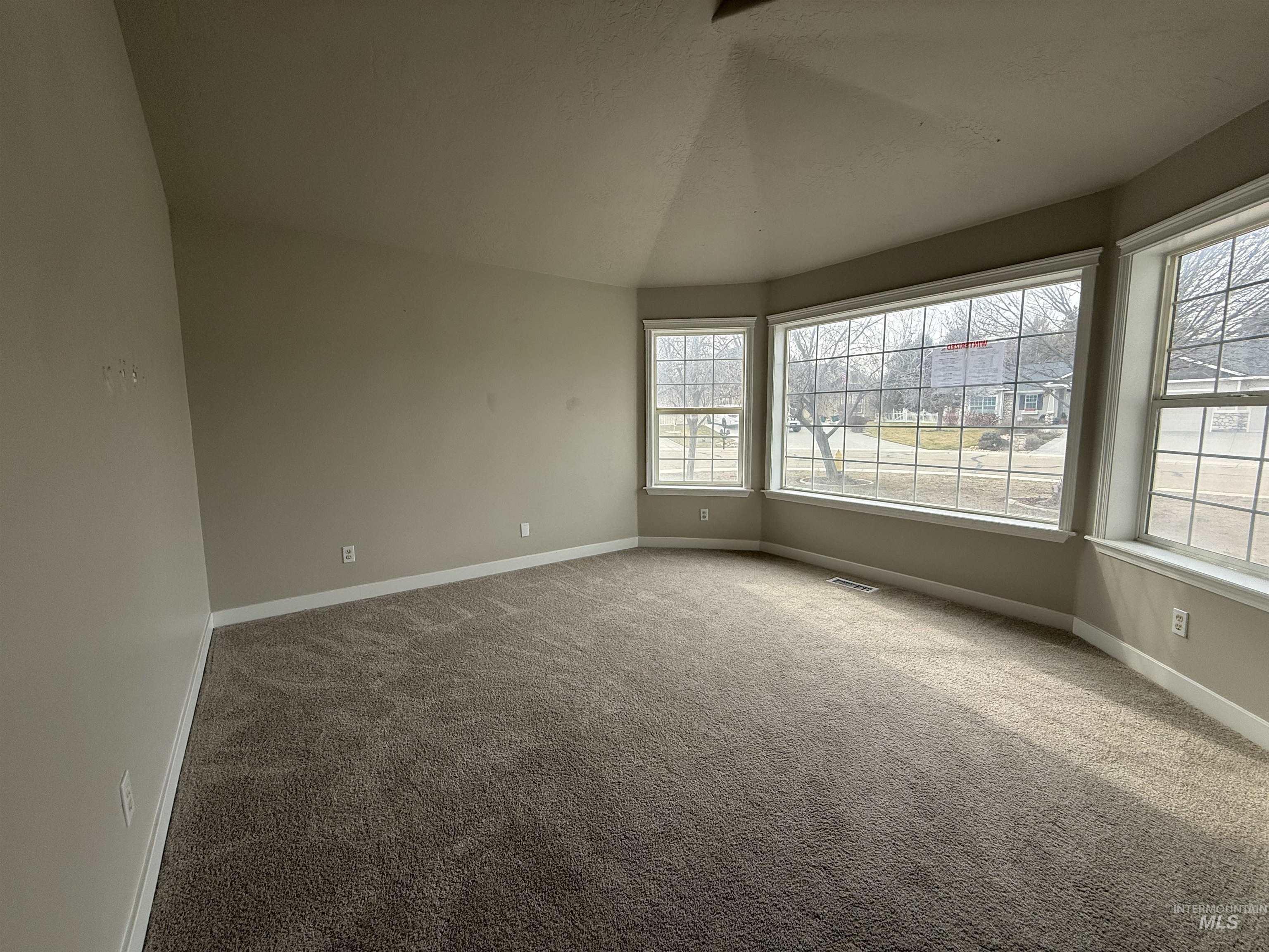 538 Morning Sun Drive Nampa, ID 83686 - Photo 5 of 28 Unfurnished room with light colored carpet and vaulted ceiling