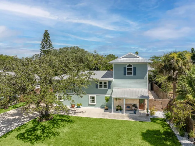 an aerial view of a house with a yard
