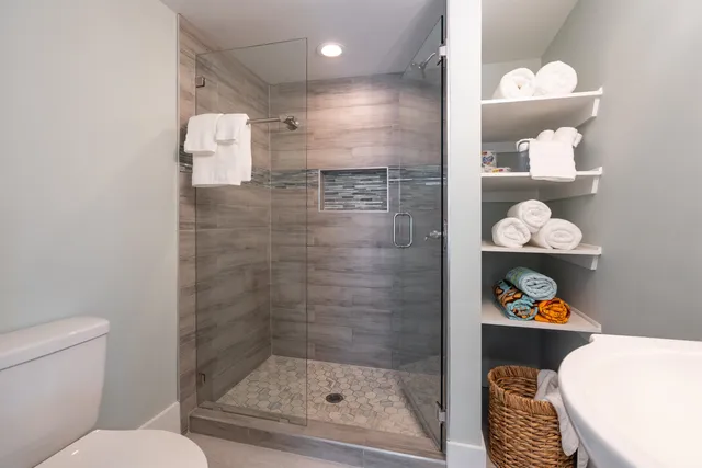 a large kitchen with stainless steel appliances granite countertop a stove a sink and a microwave