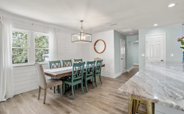 a bedroom with two beds and a chandelier
