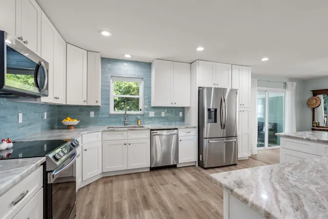 a bathroom with a granite countertop toilet sink and mirror