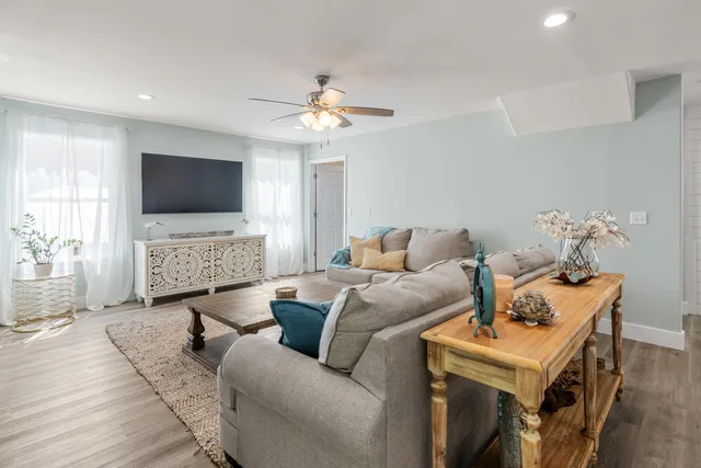 a bedroom with a bed and a flat tv screen on dresser