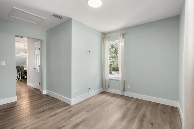 a balcony with wooden floor and yard in the back