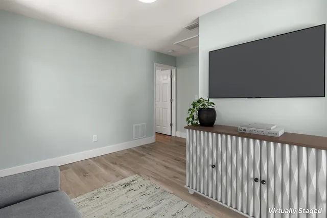 a view of a chair and table in backyard of the house