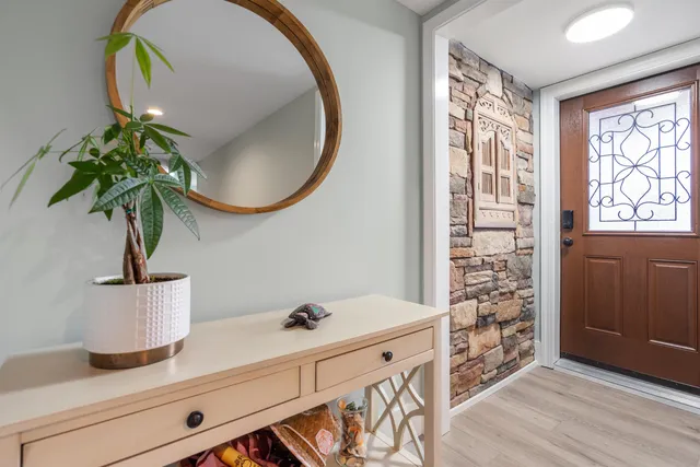 a living room with furniture and a potted plant