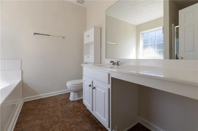 a view of a hallway with wooden floor and a window