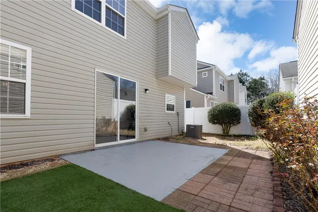 a view of a house with a yard and potted plants