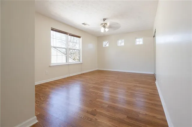 a kitchen with kitchen island white cabinets and stainless steel appliances