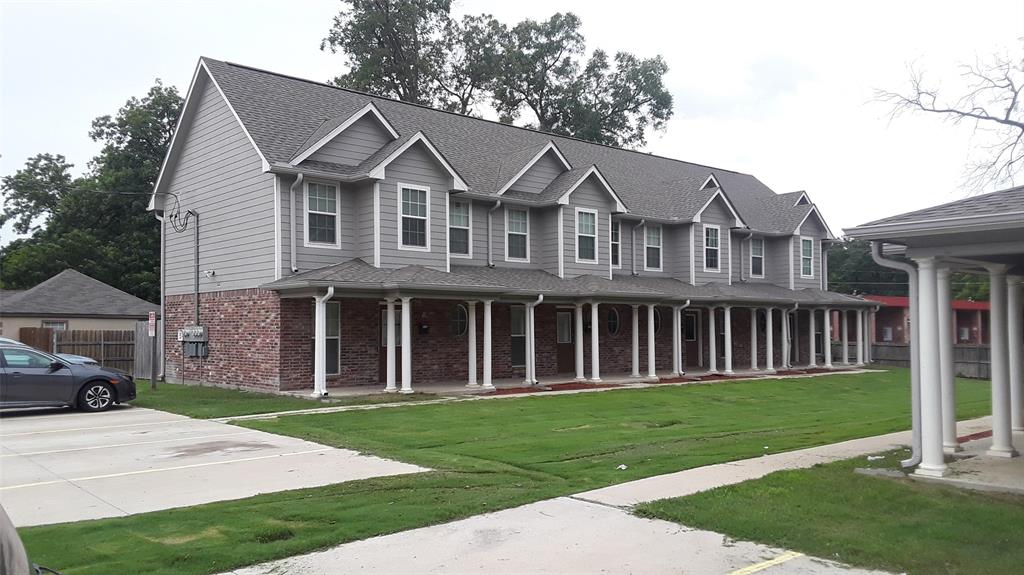 2004 Pecan Street, Unit C Commerce, TX 75428 - Photo 1 of 1 a view of a white house with a small yard and large trees