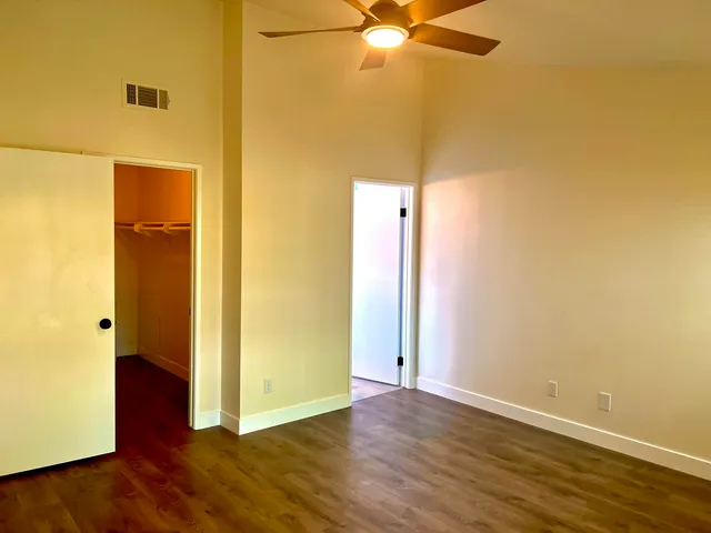 a view of a room with wooden floor