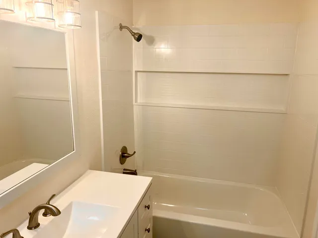 a bathroom with a bathtub and shower