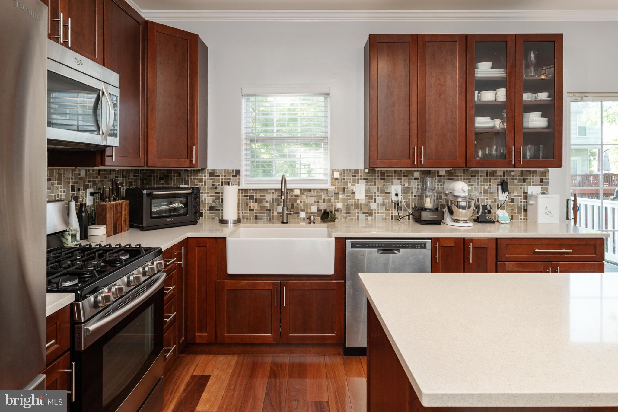 2333 Manomet Court Crofton, MD 21114 - Photo 12 of 44 a kitchen with stainless steel appliances granite countertop a stove a sink and a microwave