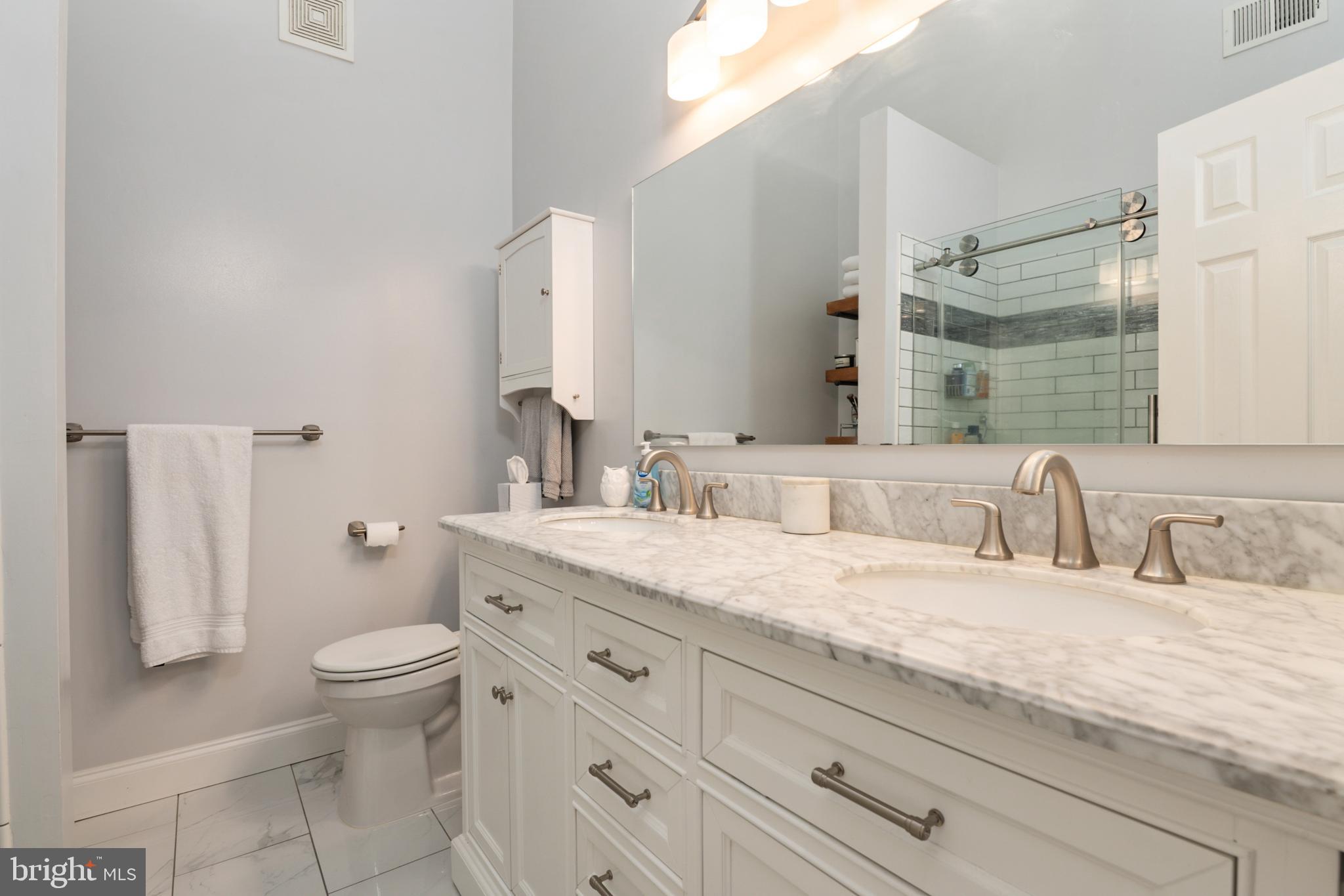 2333 Manomet Court Crofton, MD 21114 - Photo 20 of 44 a bathroom with a granite countertop toilet sink and mirror