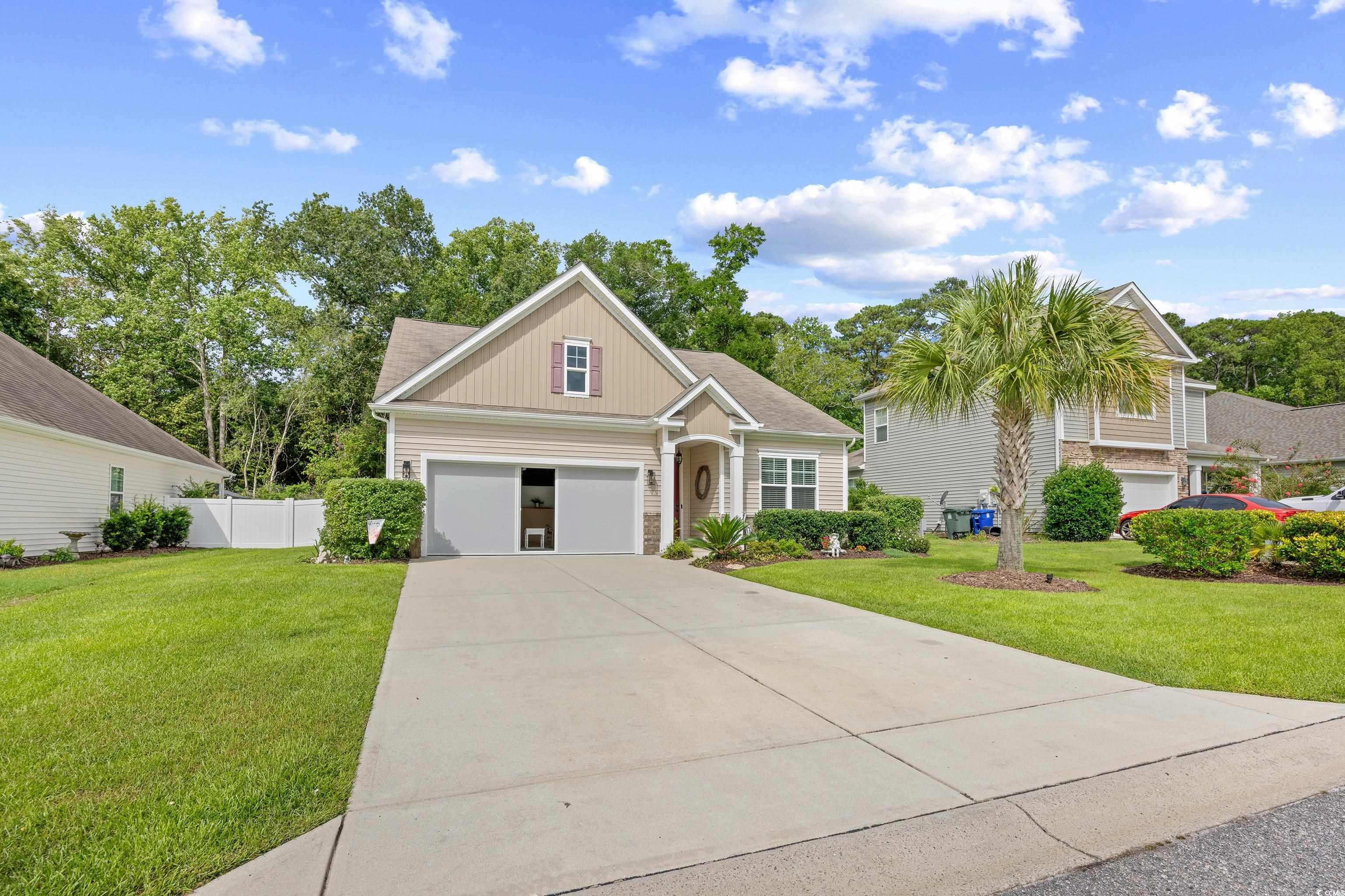 1104 Inlet View Drive North Myrtle Beach, SC 29582 - Photo 2 of 40 View of front of property featuring board and batten siding, driveway, and stone siding