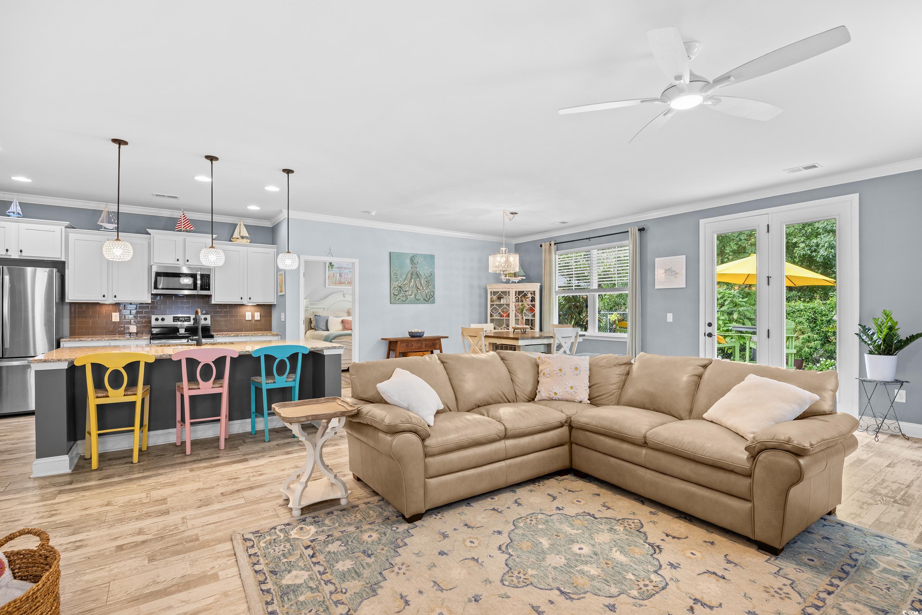 1104 Inlet View Drive North Myrtle Beach, SC 29582 - Photo 27 of 40 Living area featuring crown molding, recessed lighting, a ceiling fan, light wood-style flooring, and french doors