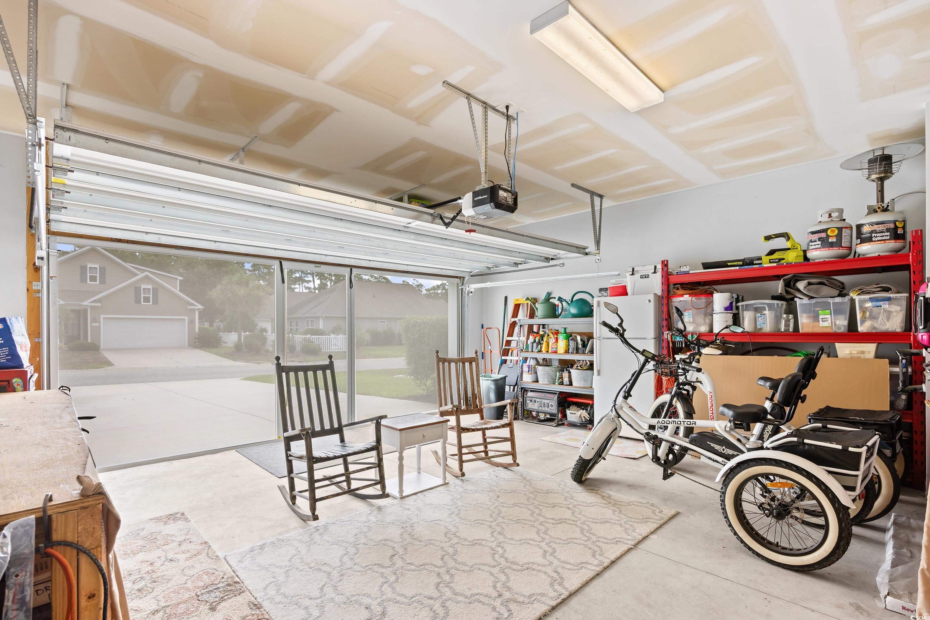 1104 Inlet View Drive North Myrtle Beach, SC 29582 - Photo 28 of 40 Garage with freestanding refrigerator and a garage door opener