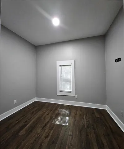 a view of wooden floor and windows in a room