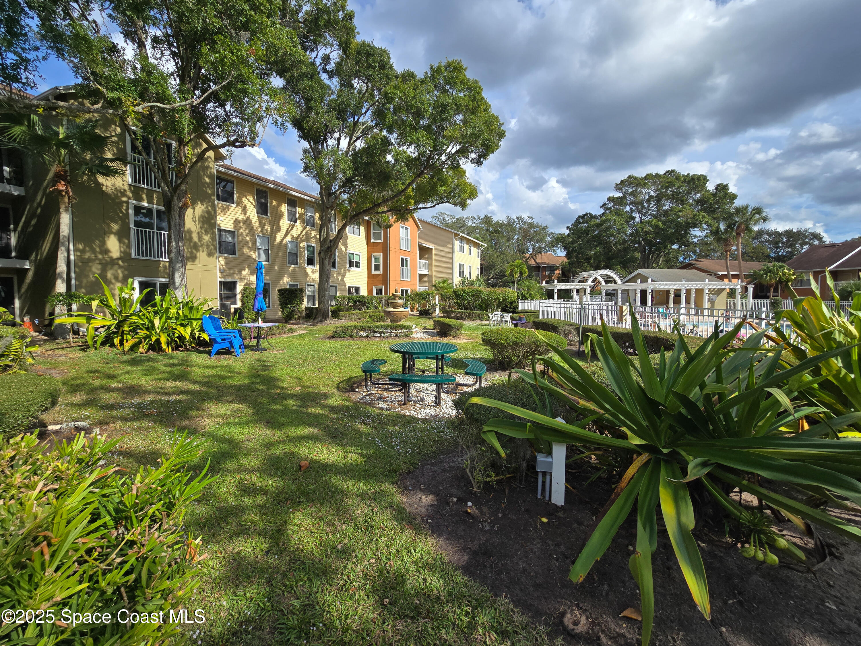 225 South Tropical Trail, Unit 217 Merritt Island, FL 32952 - Photo 17 of 18 a view of a park with plants and trees