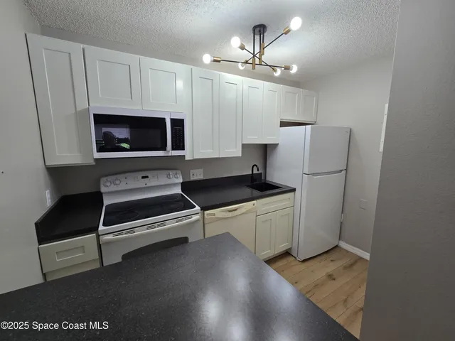 a kitchen with stainless steel appliances a refrigerator a stove a microwave and cabinets