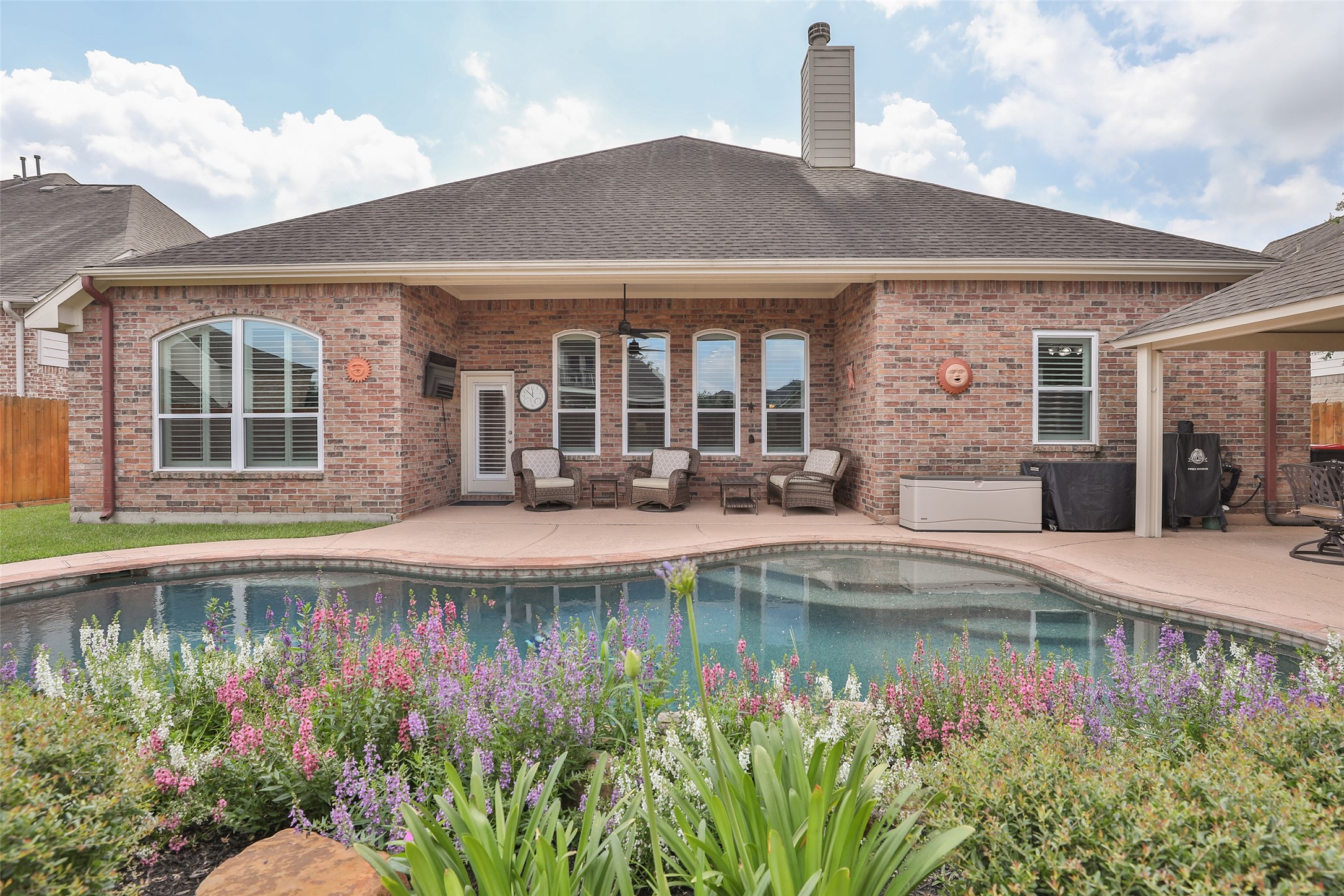 20519 Windrose Bend Drive Spring, TX 77379 - Photo 27 of 37 This backyard is an owner's dream! It features a covered back porch for relaxing, a sparkling pool to cool off in, and an additional covered patio complete with an outdoor kitchen —the perfect spot for entertaining guests or watching the big game.