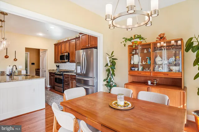 a kitchen with a table chairs stove and refrigerator
