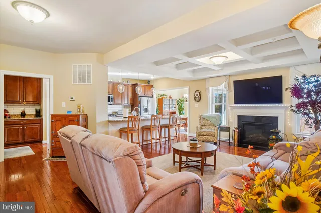 a living room with furniture fireplace and a table