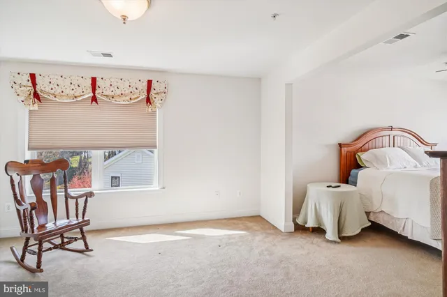 a view of a room with furniture and a window