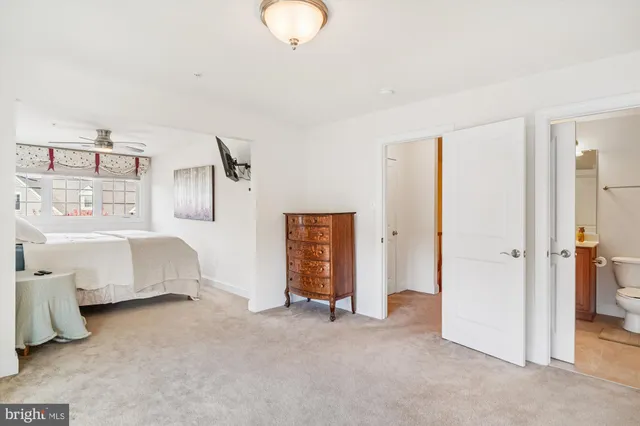 a bedroom with bed and closet