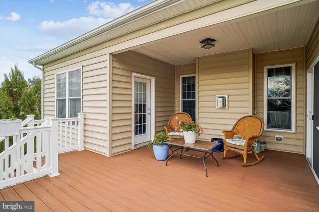 a backyard of a house with barbeque oven table and chairs