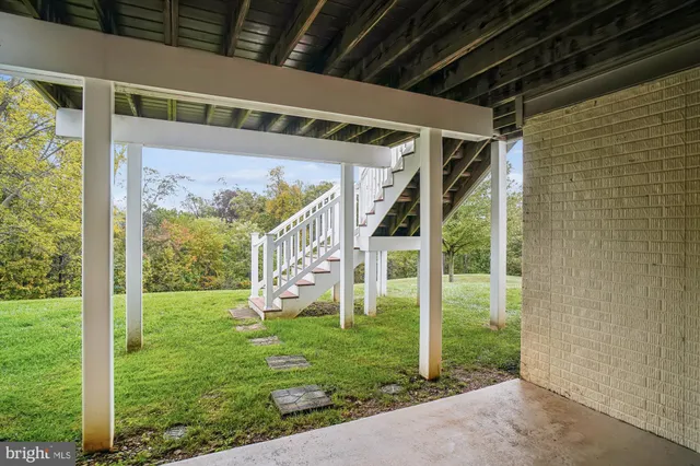 a view of a porch with a big yard and plants