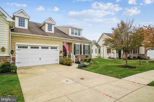 a front view of a house with a garden and pathway