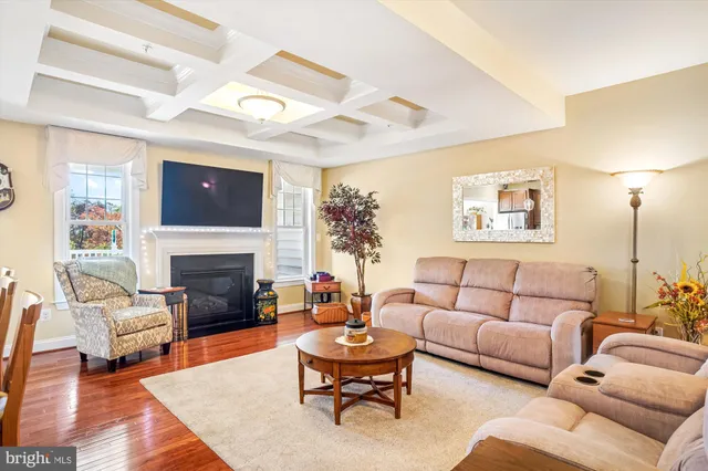 a living room with furniture fireplace and a large window